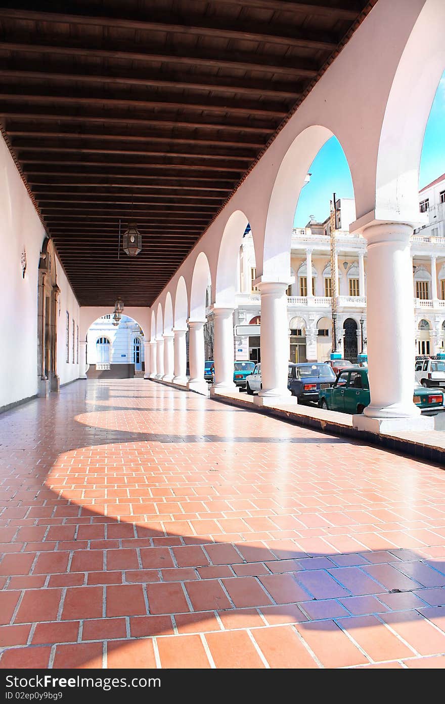 Passway between wall and pillars. Ancient architecture in colonial style in Santiago de Cuba, Cuba