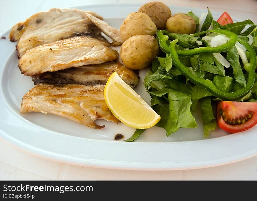 Roast cutlet of pork with boiled potatoes and salad