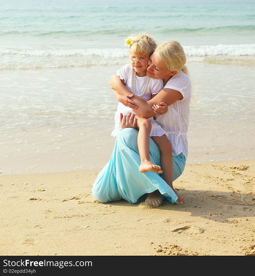 Little girl with her mother on sea