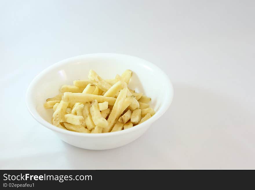 Delicious french fry sticks in a bowl on white background. Delicious french fry sticks in a bowl on white background.