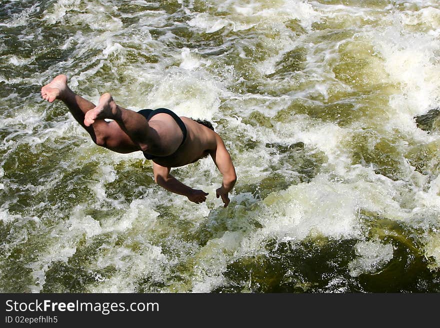 An image of a man jumping into a river