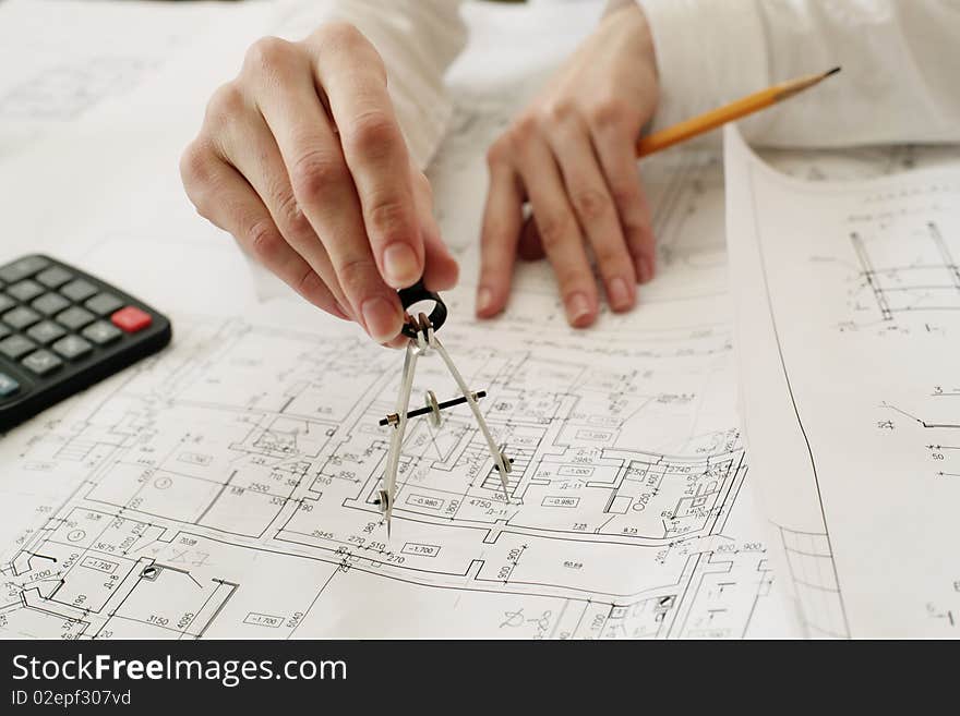 An image of metal calipers in a hand, focus on a hand. An image of metal calipers in a hand, focus on a hand