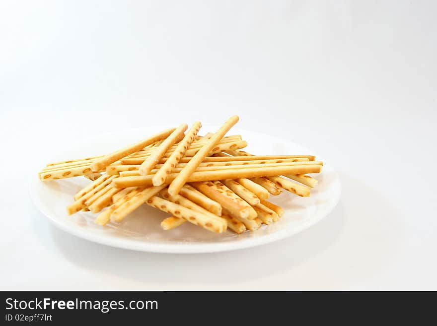 A famous asian snack called cracker sticks served in a plate.