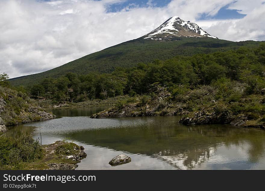 A well forested mountain with a snow covered peak - Tierra Del Fuego. A well forested mountain with a snow covered peak - Tierra Del Fuego