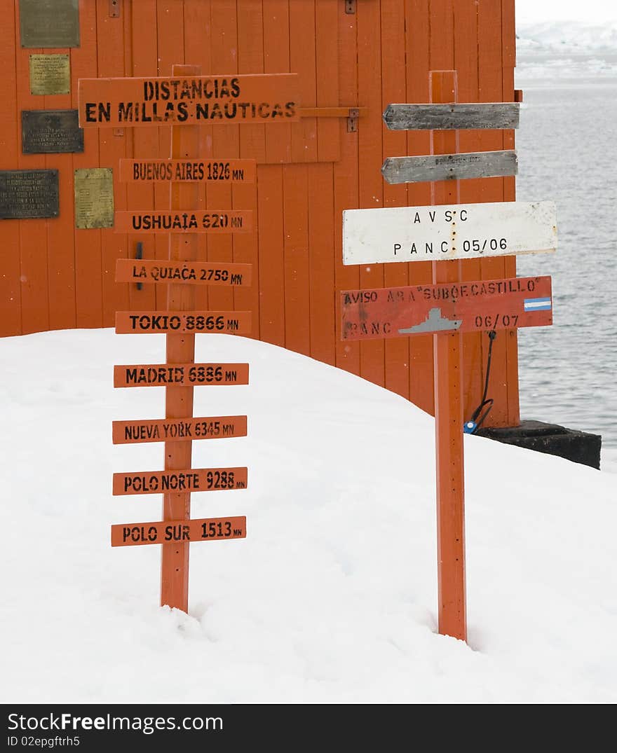 A sign post in the Antarctic depicting the distances to various locations around the world. A sign post in the Antarctic depicting the distances to various locations around the world.