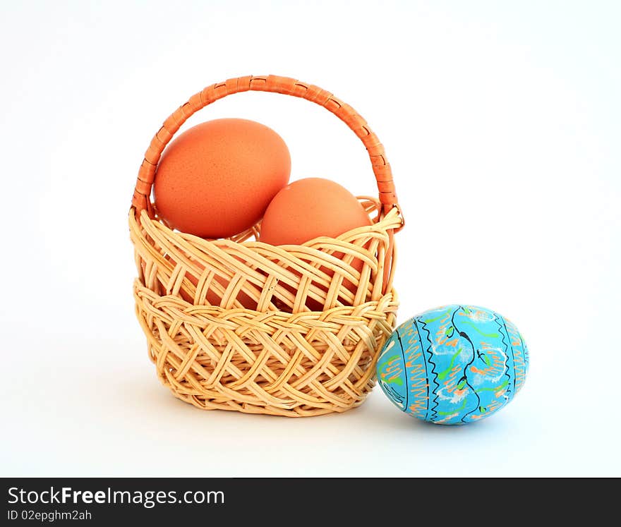 An image of easter eggs in a little basket. An image of easter eggs in a little basket