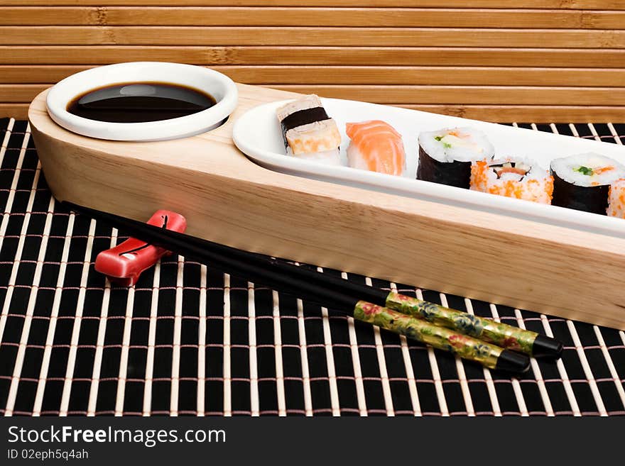 An image of a set of tasty sushi and chopsticks