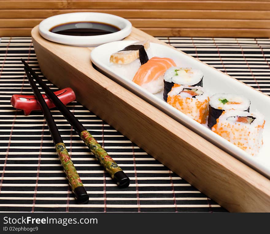 An image of a set of tasty sushi and chopsticks