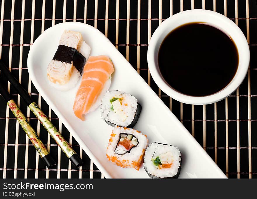 An image of a set of sushi and soy