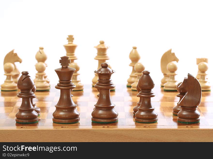 Chessmen on the board on white background. Chessmen on the board on white background