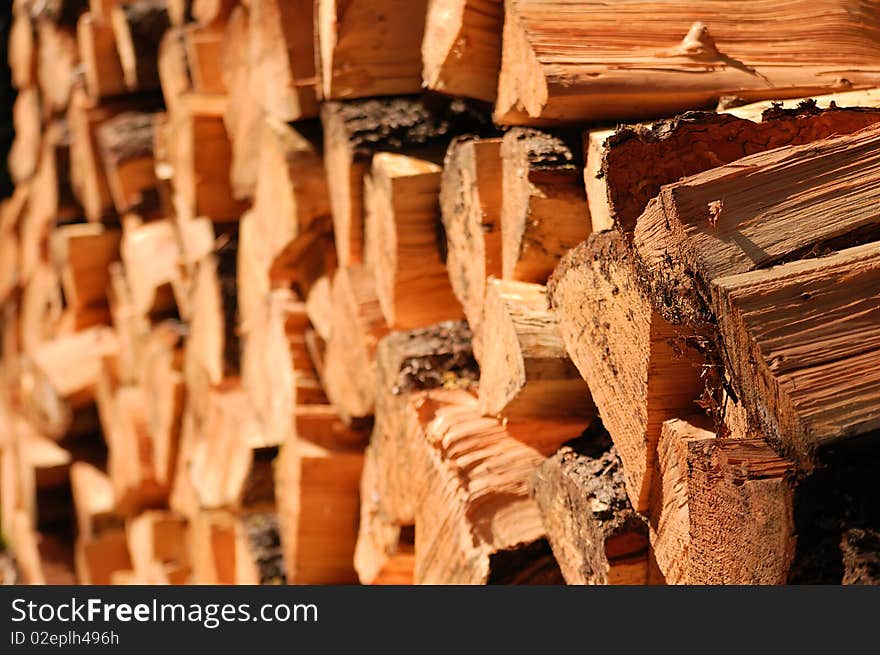 Split firewood stacked up in a big neat pile.