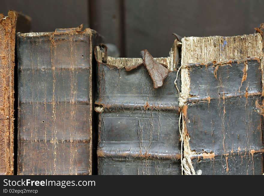 Three old books with tattered bindings