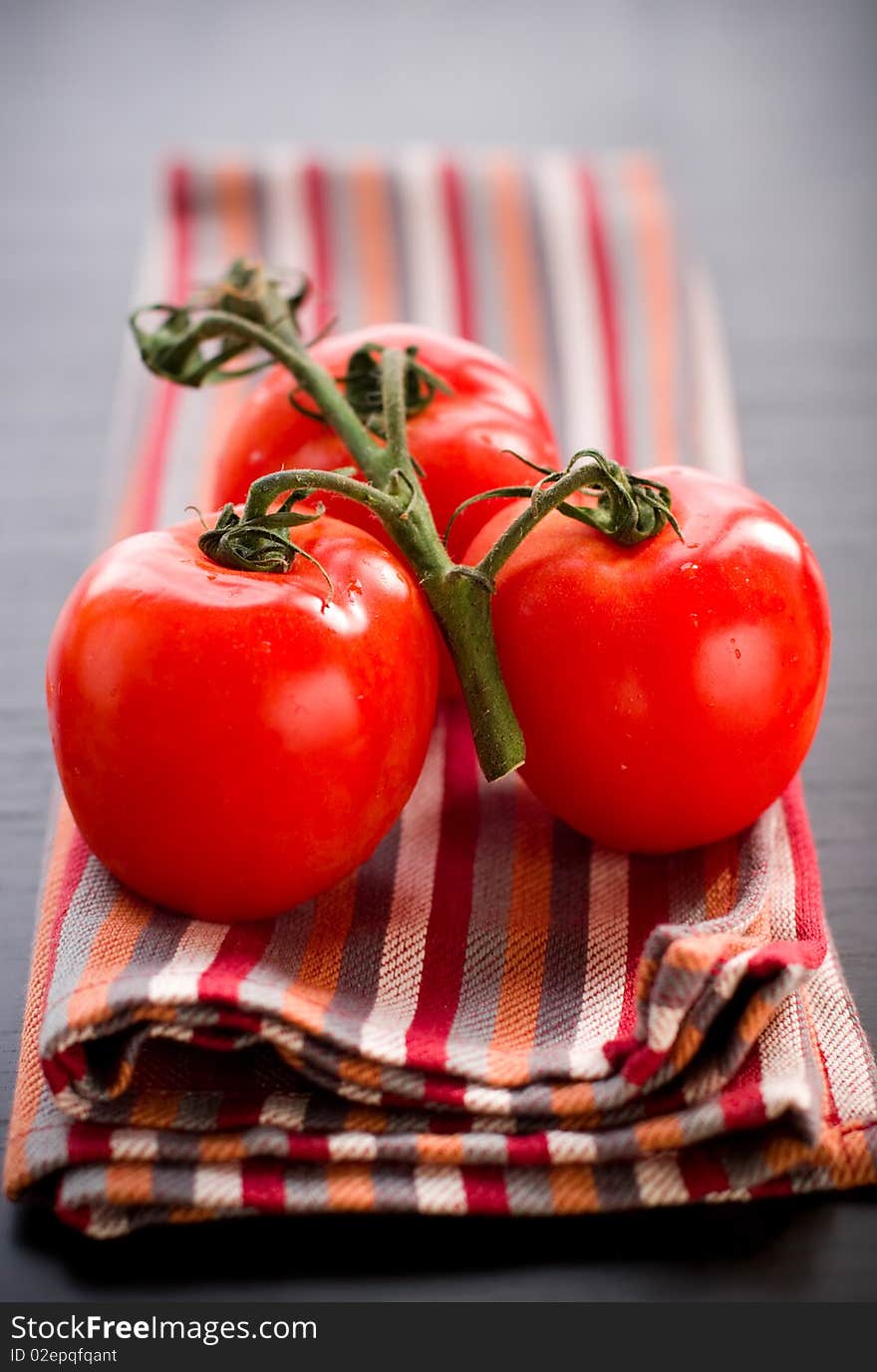 Fresh tomato branch on the table. Fresh tomato branch on the table