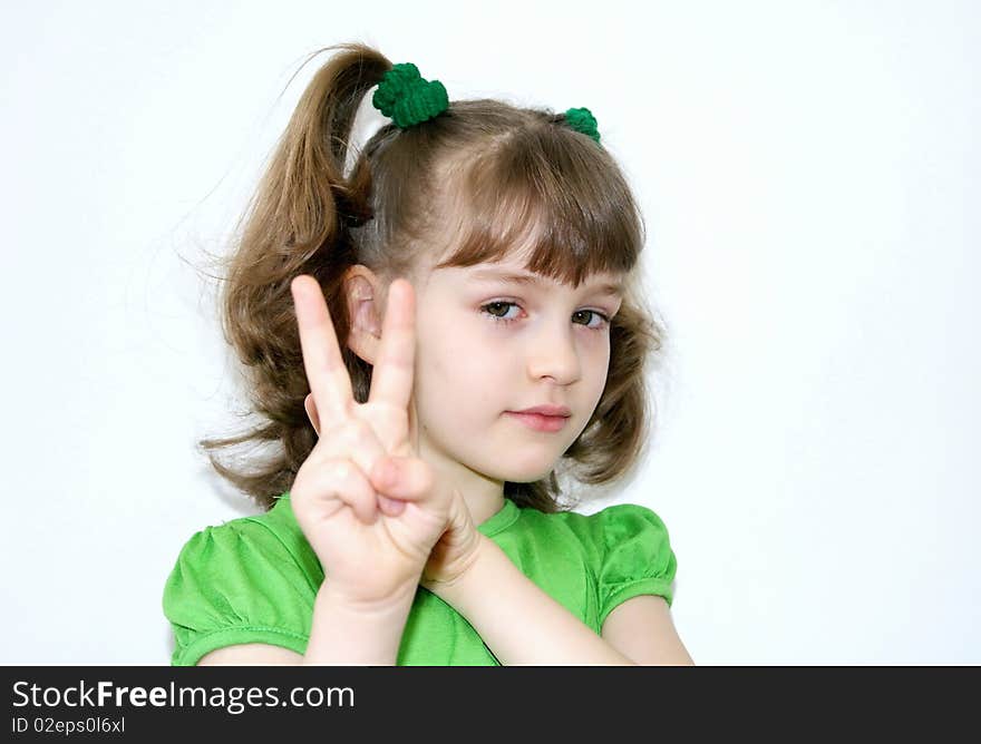 The beautiful girl with short hair in a green dress holds before itself a hand. The beautiful girl with short hair in a green dress holds before itself a hand