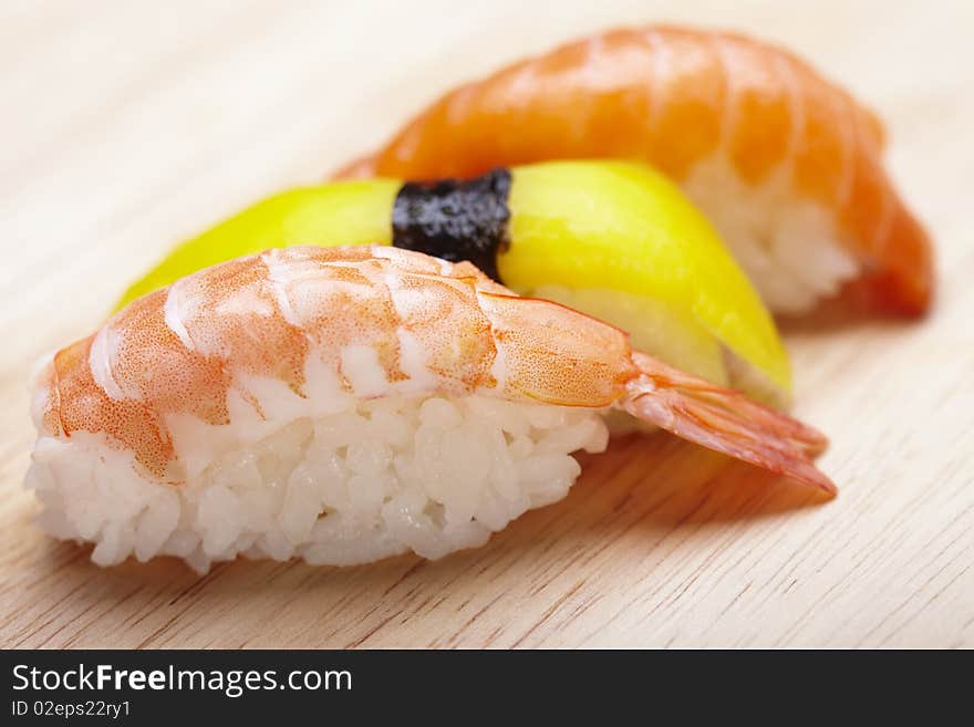 Tasteful Japanese sushi over bamboo background.