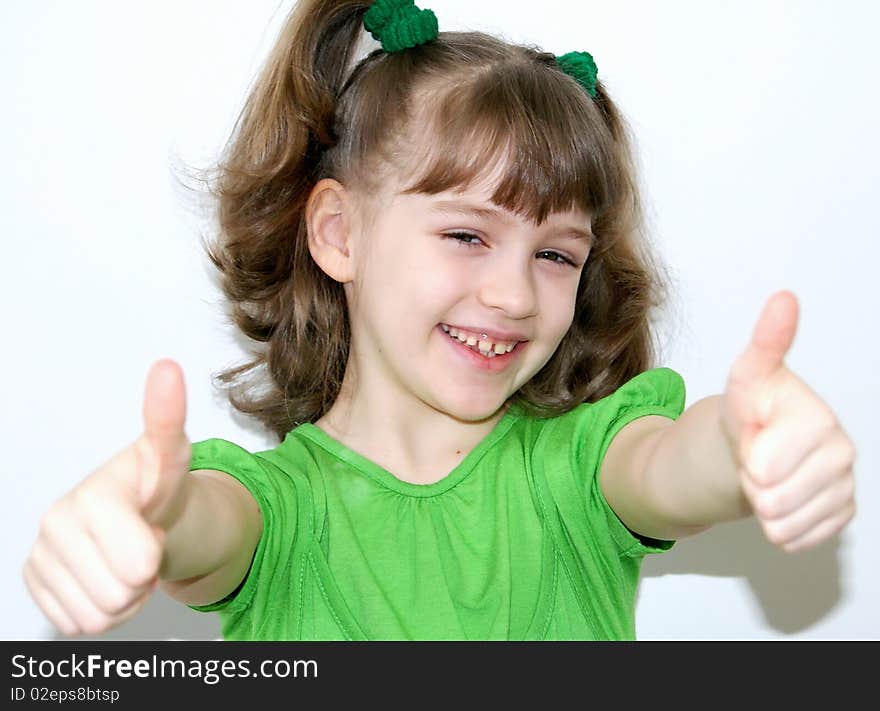 The happy girl with short hair in a green dress has extended before itself hands. The happy girl with short hair in a green dress has extended before itself hands