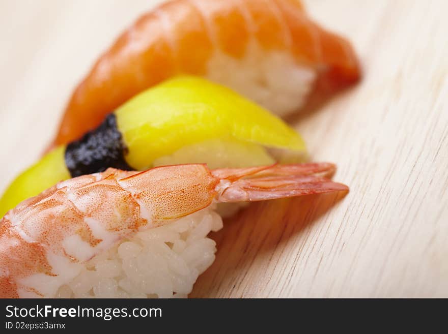 Tasteful Japanese sushi over bamboo background.