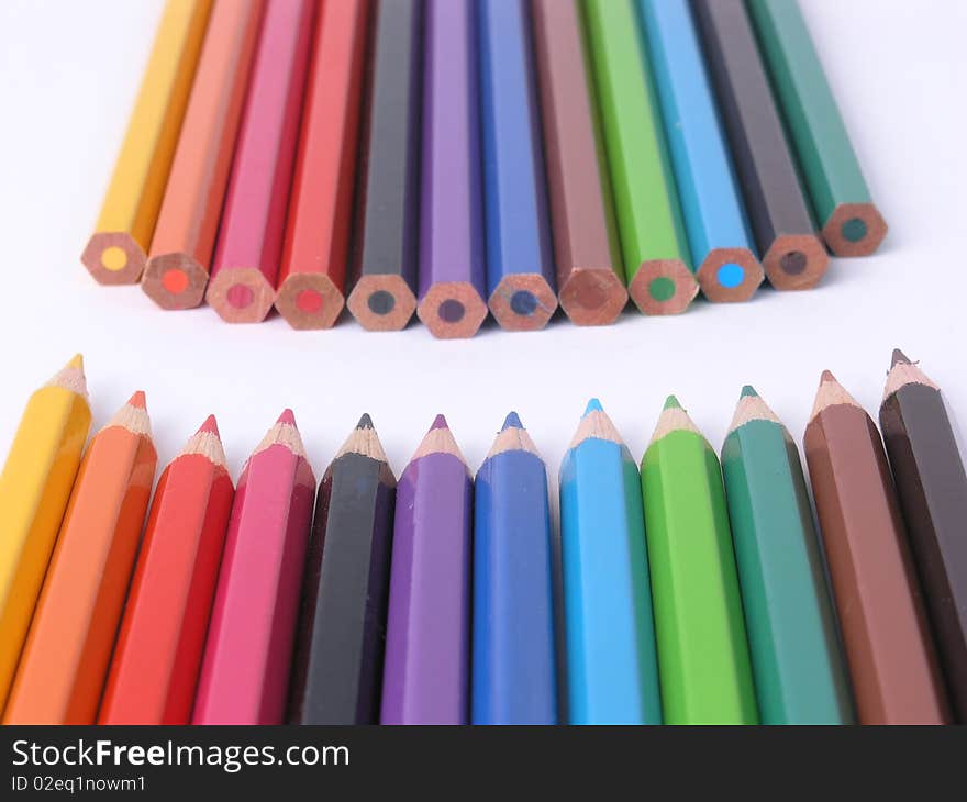 Two rows of colorful wooden crayons