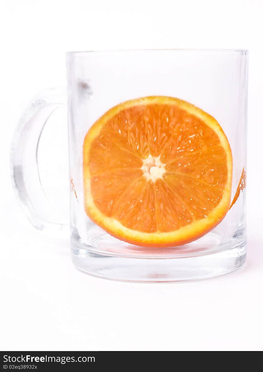 Juicy orange in glass on white background