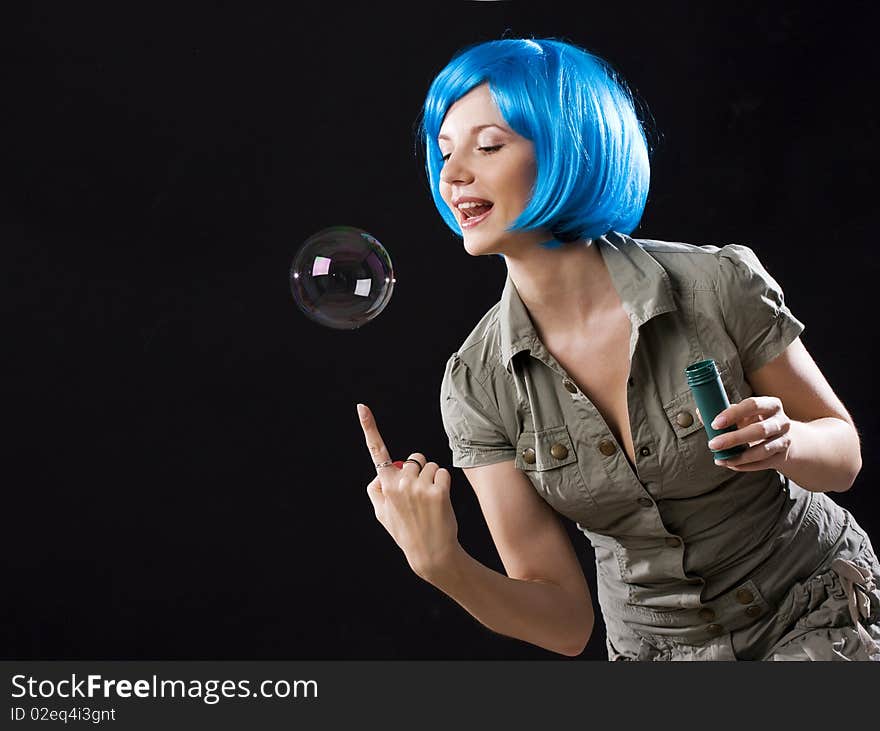 Woman in blue wig with soap bubbles. Woman in blue wig with soap bubbles