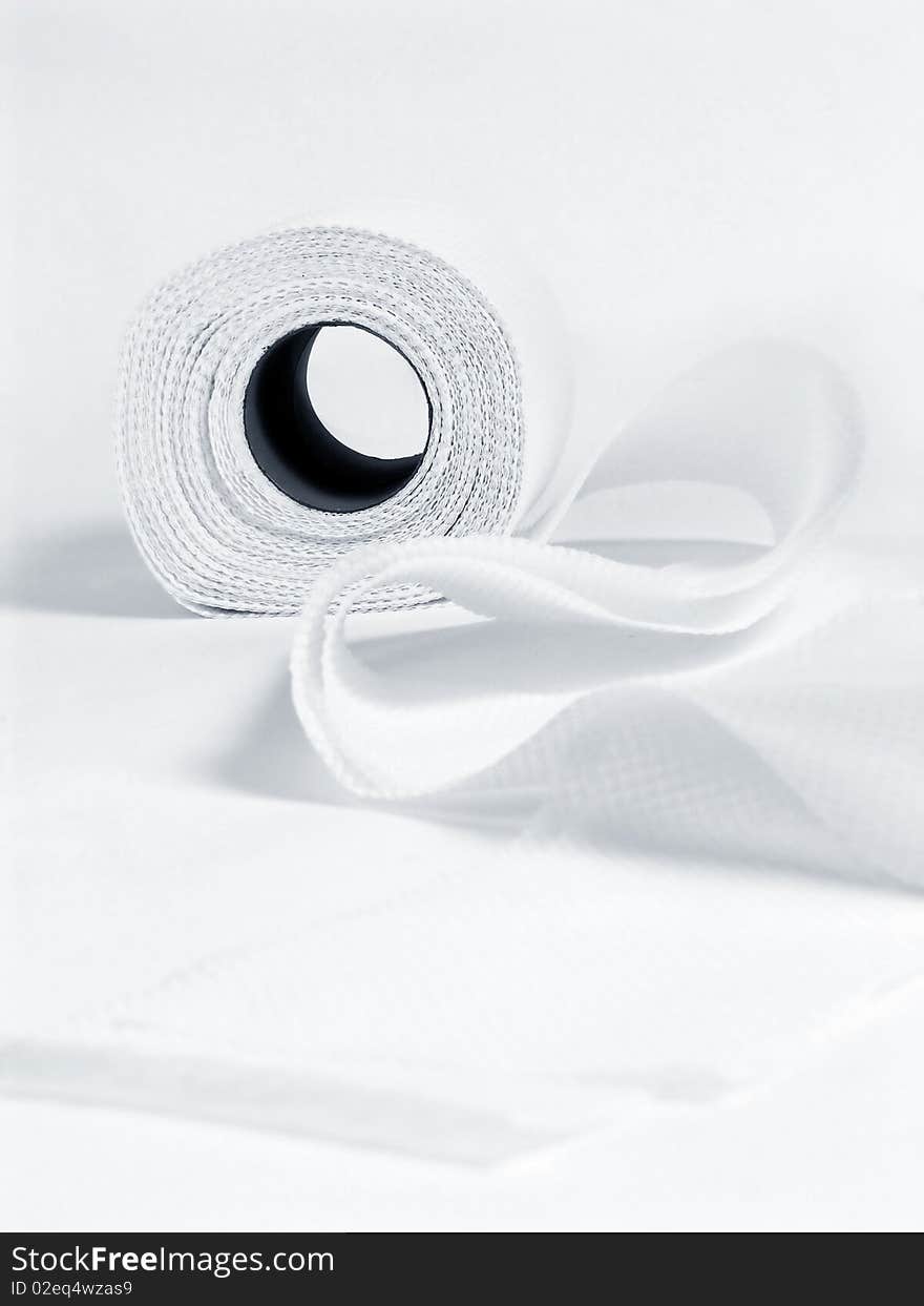 Roll of white toilet paper, on white background with shadow