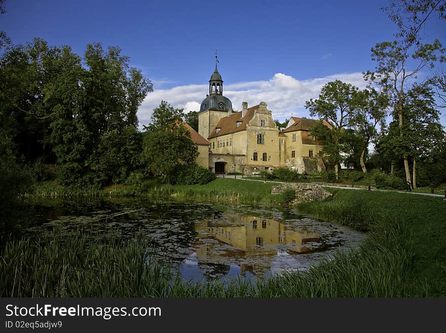 Latvian landscape vith old Straupe castle and reflection of it. Straupe is a village in the P?rgauja municipality of Latvia. Until the thirteenth century it was a part of the ancient Idumea country, later became the trade center known in German as Roop, and received its town privileges in 1374. During the fourteenth century, Straupe flourished as part of the mercantile Hanseatic League.