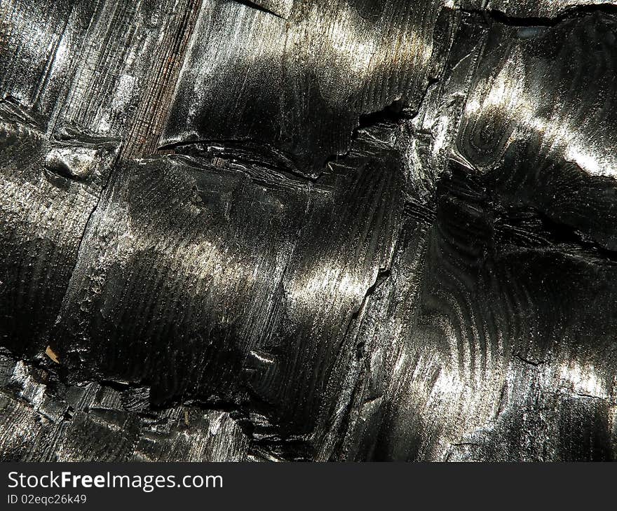 Black shiny charcoal after fire