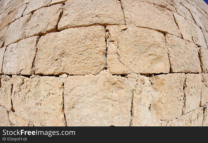 Convex ancient stone wall texture of beige sandstone blocks