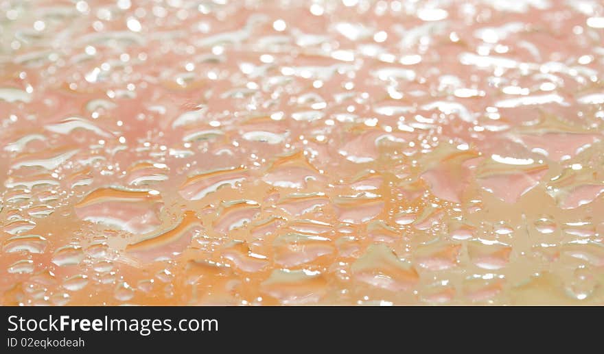 Water drops on glass glare on the droplets, bokeh