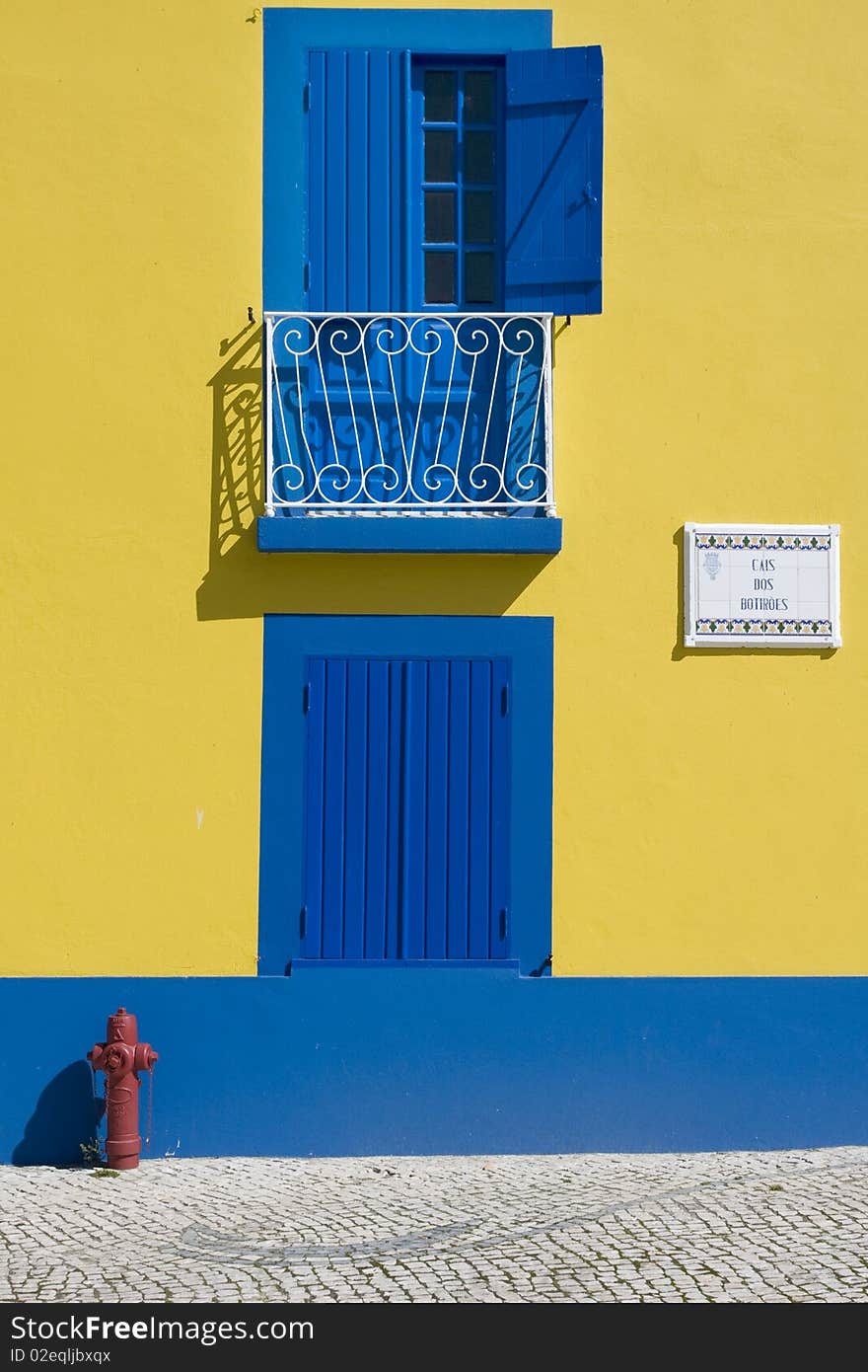 Detail of old houses facade in yellow and blue