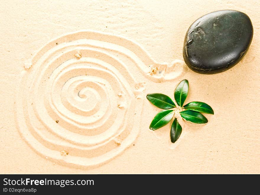 Zen stone, leaf on sand