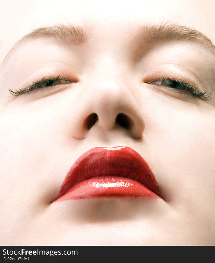 Women face with shiny red lips. Women face with shiny red lips