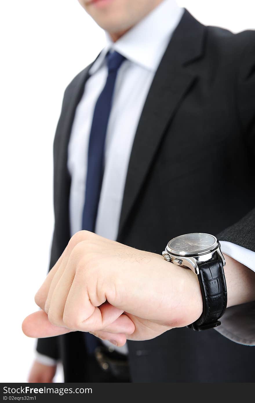 A businessman is looking at clock