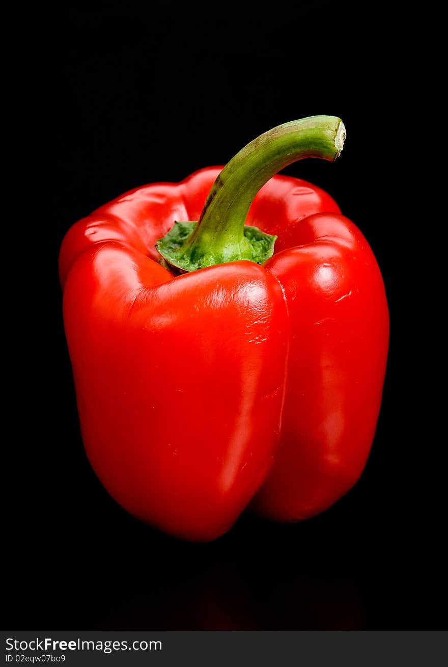 It is red, sweet Bulgarian pepper on black background. It is red, sweet Bulgarian pepper on black background