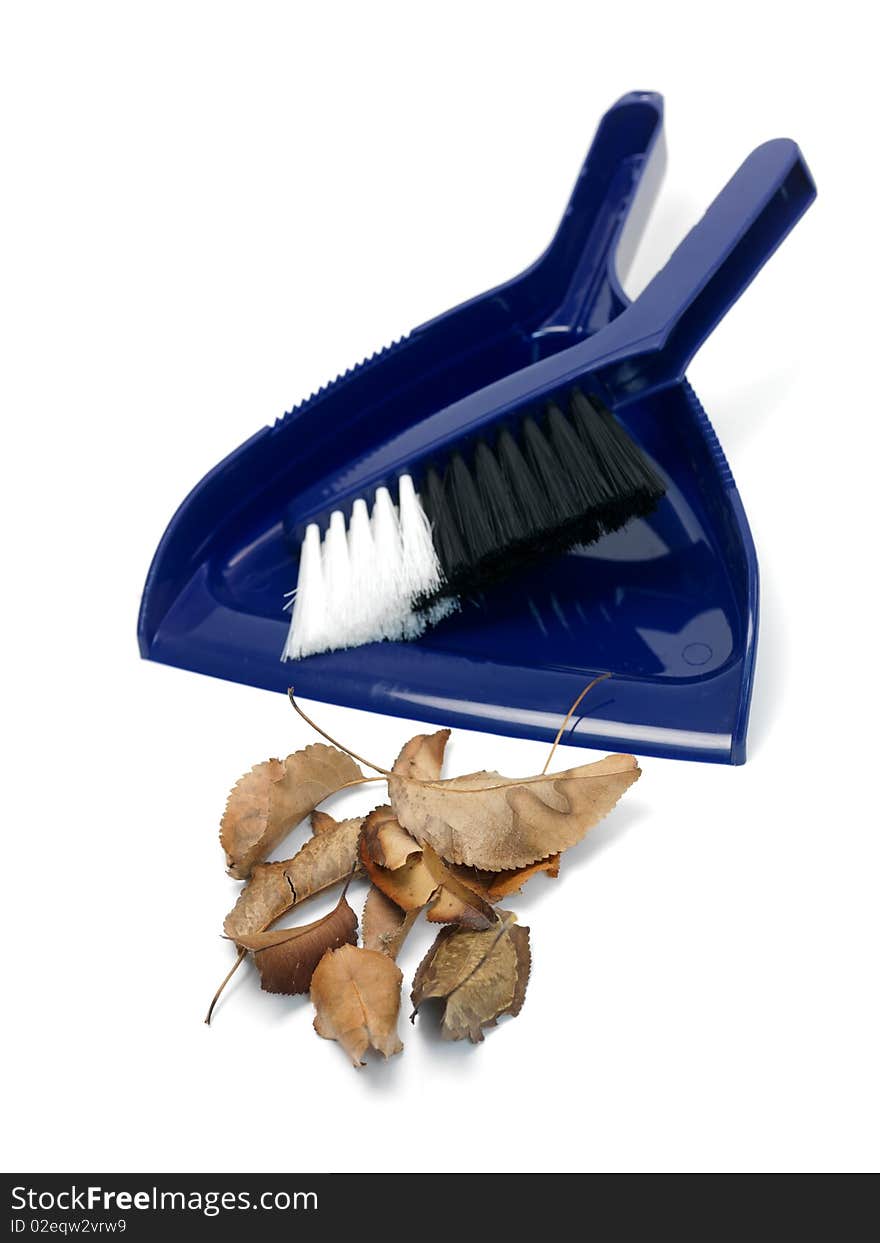 A dust pan and brush isolated against a white background. A dust pan and brush isolated against a white background