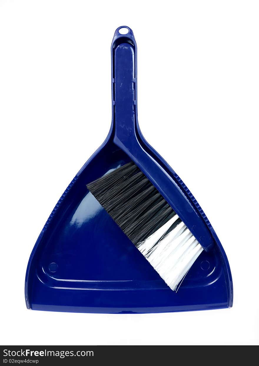 A dust pan and brush isolated against a white background. A dust pan and brush isolated against a white background