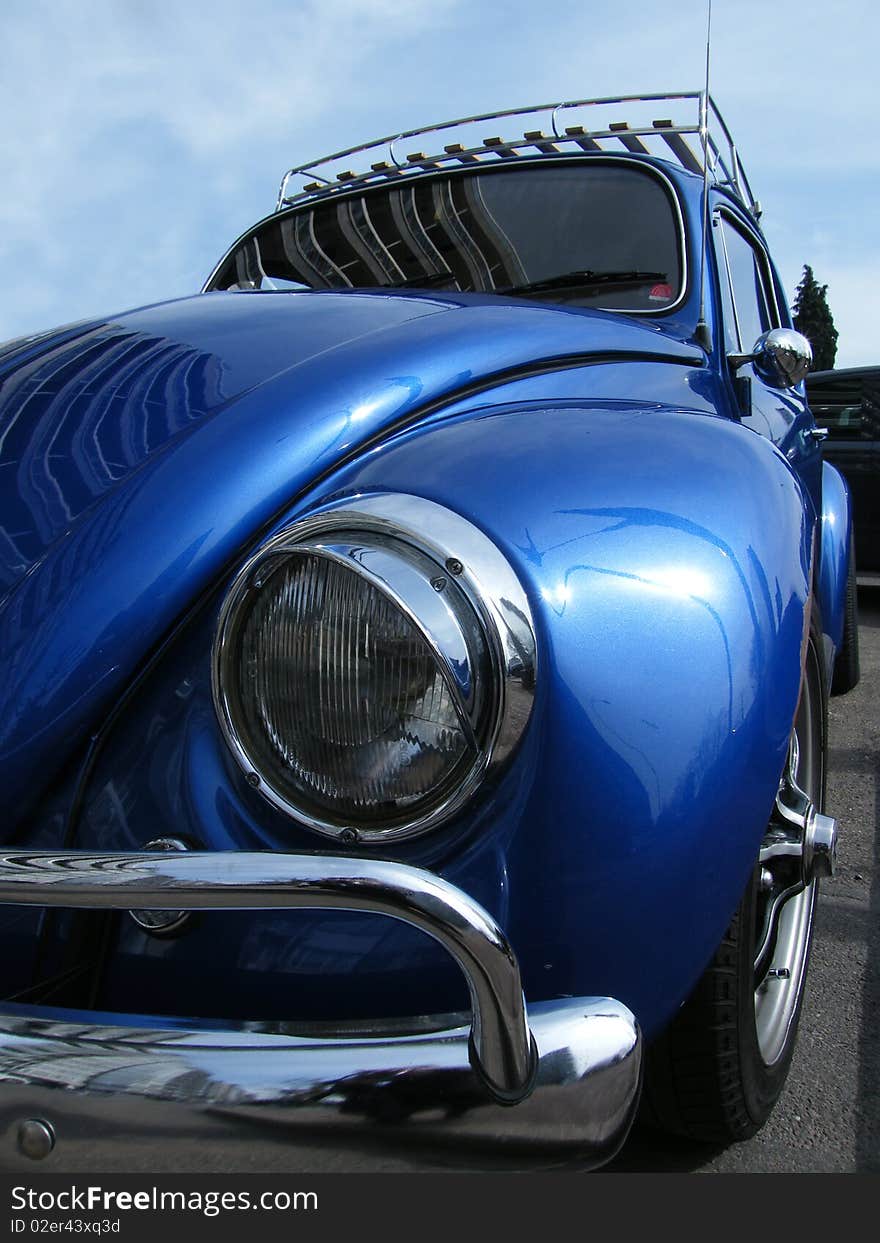 Front of a small car with a large lamp. Front of a small car with a large lamp