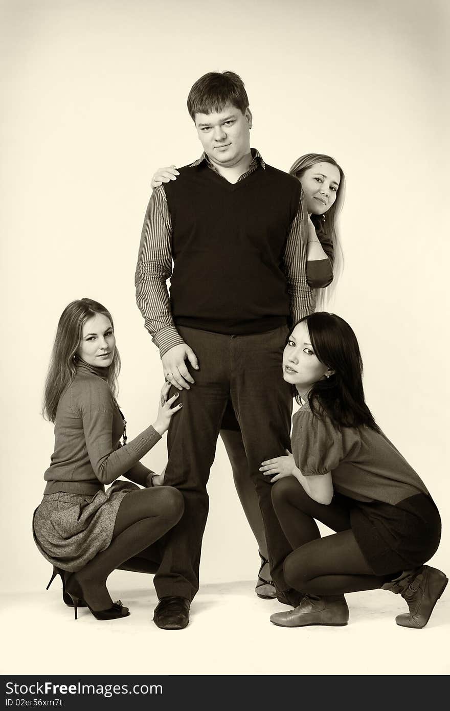 Three girls around one man on a white background