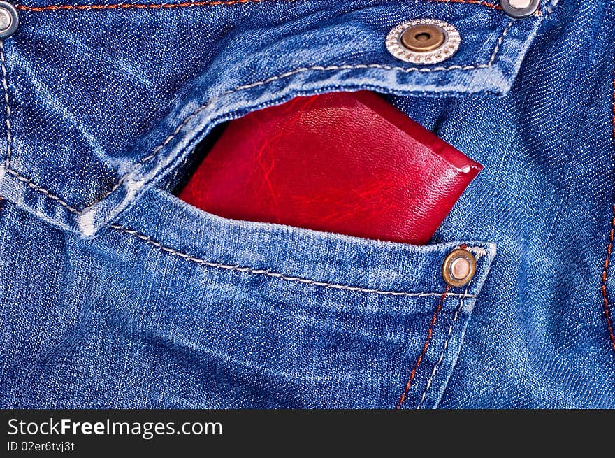 Red documents in back blue jeans pocket. Red documents in back blue jeans pocket