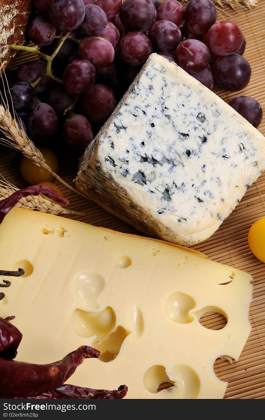 Close up with moldy cheese, grain and grapes isolated. Close up with moldy cheese, grain and grapes isolated