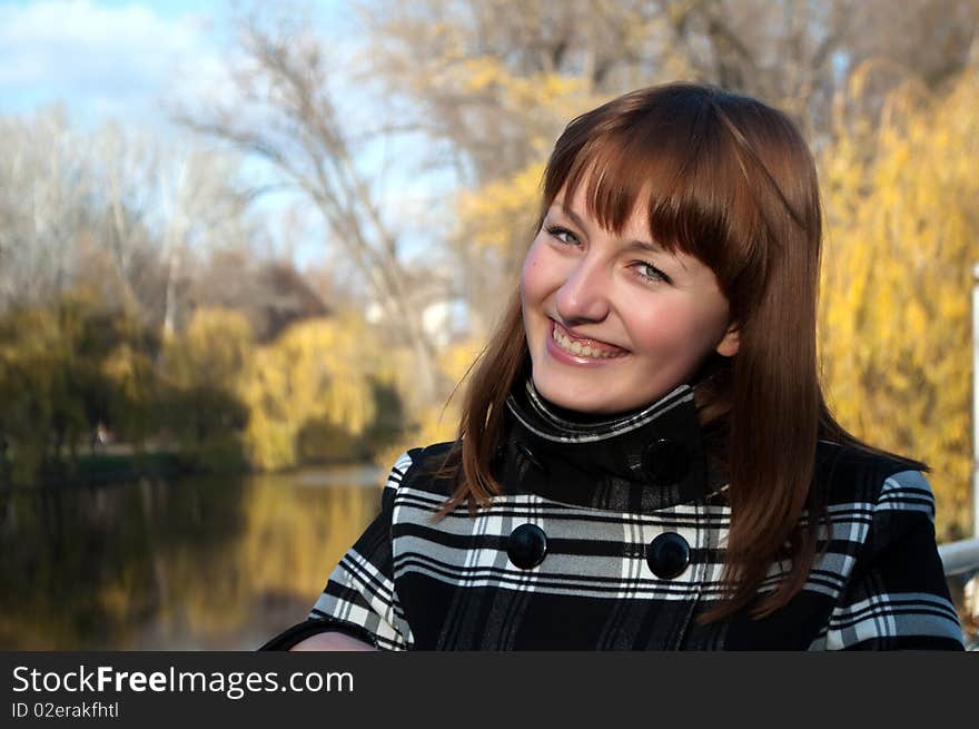 Young cute girl in autumn park