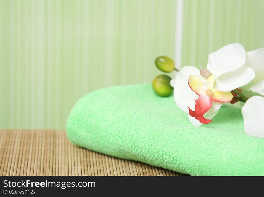 Bathroom in green tones. Towel green it is a white orchid. Bathroom in green tones. Towel green it is a white orchid