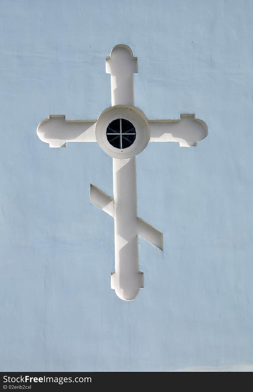 The engraved cross on a stone wall. The engraved cross on a stone wall