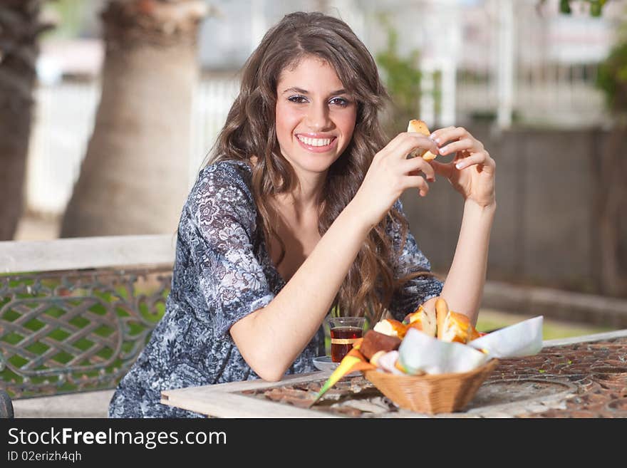 Young woman having breakfast outside