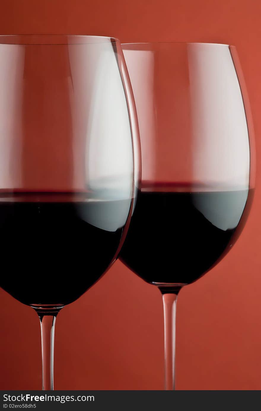 Photo of a wine glass on a red background. Photo of a wine glass on a red background