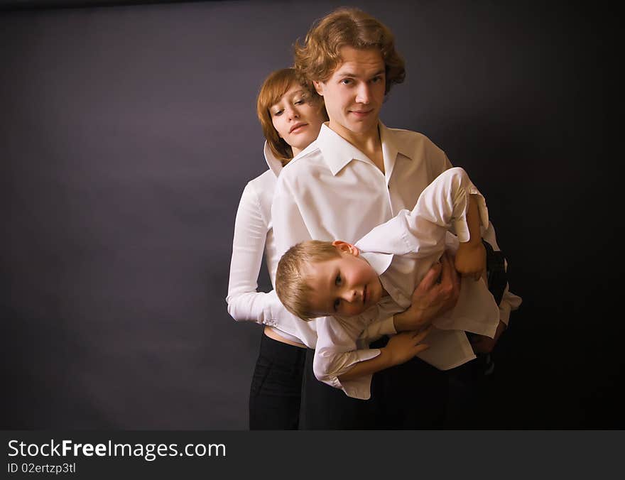 Portrait of a family - parents and their son, father holding boy in his arms. Portrait of a family - parents and their son, father holding boy in his arms