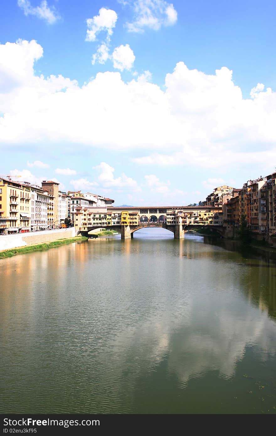 View of historical old bridge in florence with clouds at the horizon. View of historical old bridge in florence with clouds at the horizon