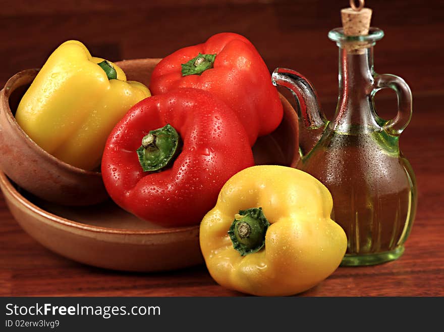 raw peppers in bowls and small bottle of olive oil. raw peppers in bowls and small bottle of olive oil