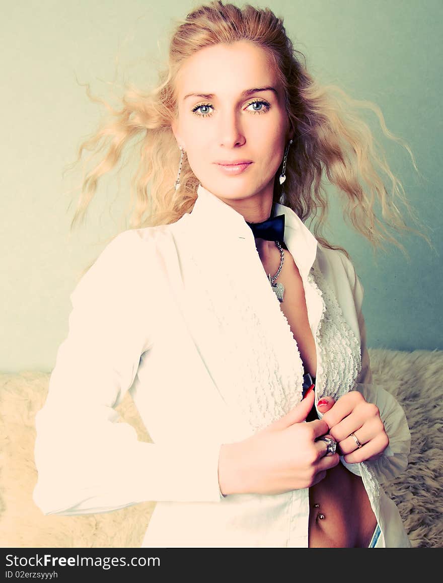 Portrait of a blond girl in white blouse