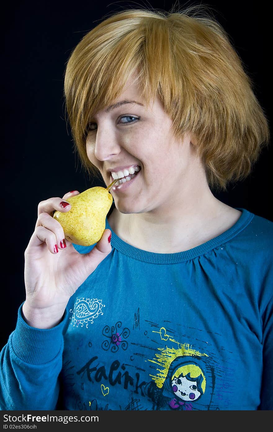 Cute young blond girl holding a pear. Cute young blond girl holding a pear